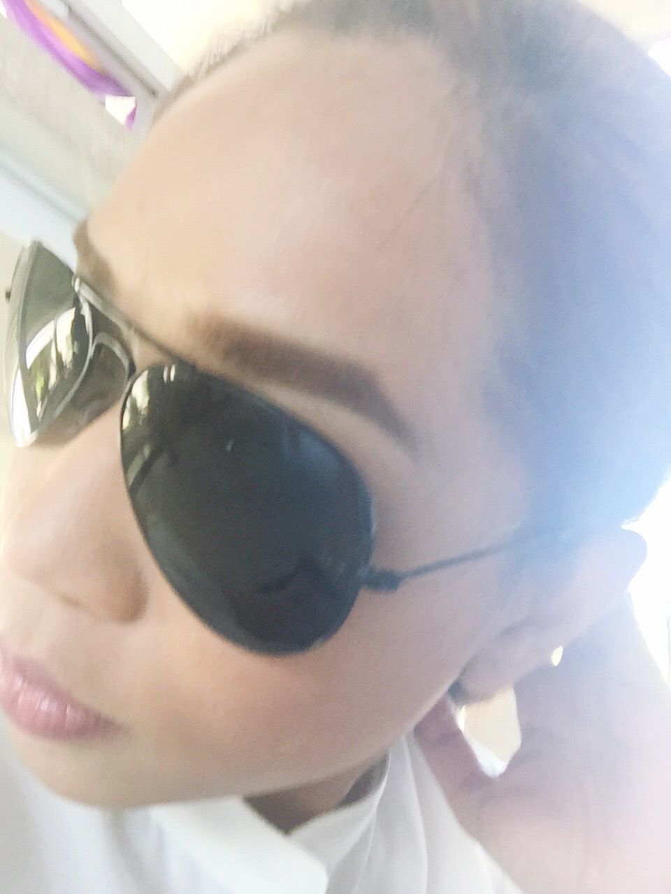 person, lifestyles, part of, holding, close-up, cropped, leisure activity, headshot, indoors, human finger, young adult, sunglasses, reflection, human face, young women