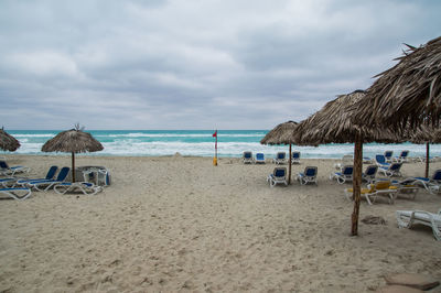 Deserted cuban beach in bad weather, dark clouds over the sea.