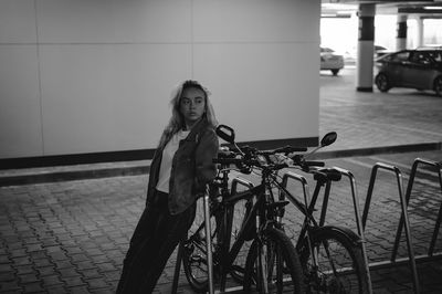 Woman standing by bicycle at basement