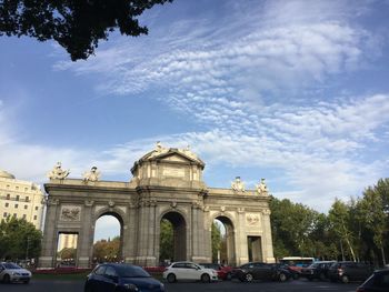 Cars in city against sky