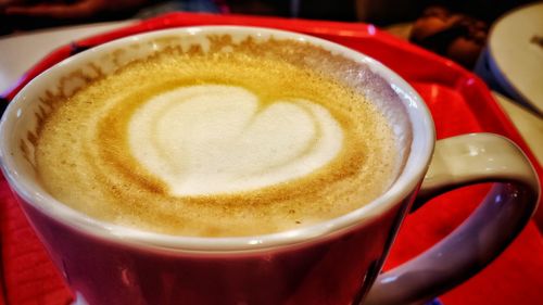 Close-up of cappuccino served on table