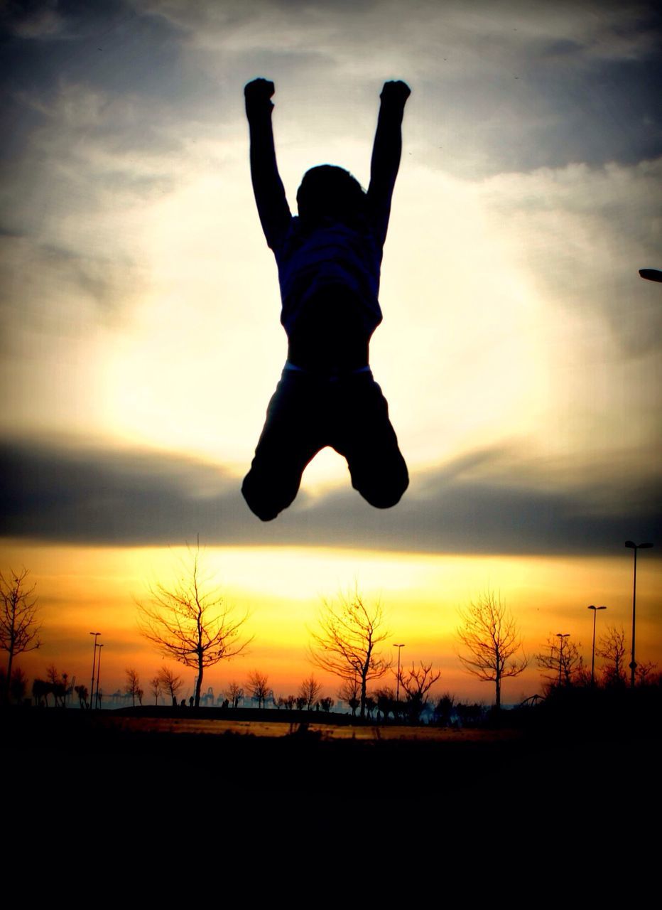 sunset, silhouette, sky, lifestyles, leisure activity, full length, cloud - sky, orange color, men, cloud, nature, beauty in nature, mid-air, tranquility, beach, standing, scenics, side view