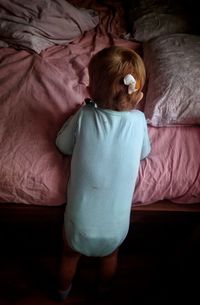 High angle view of woman relaxing on bed at home