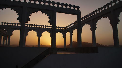 Low angle view of built structure against sky during sunset