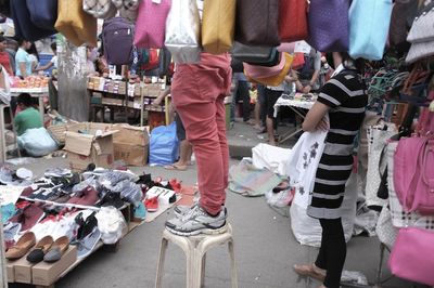 Low section of people at market stall