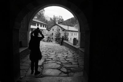 Woman walking in archway