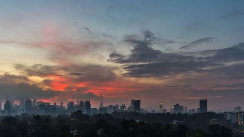 Scenic view of buildings against sky during sunset