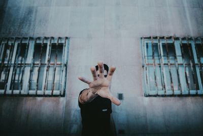 Low section of woman hand on the wall