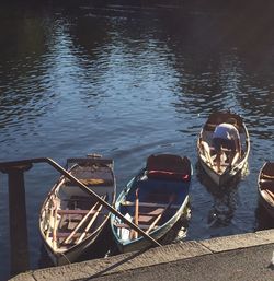 Boats moored at jetty in lake