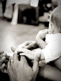 Midsection of couple holding hands