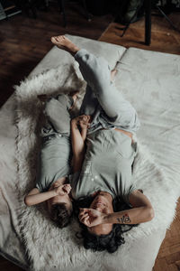 High angle view of woman lying on bed at home