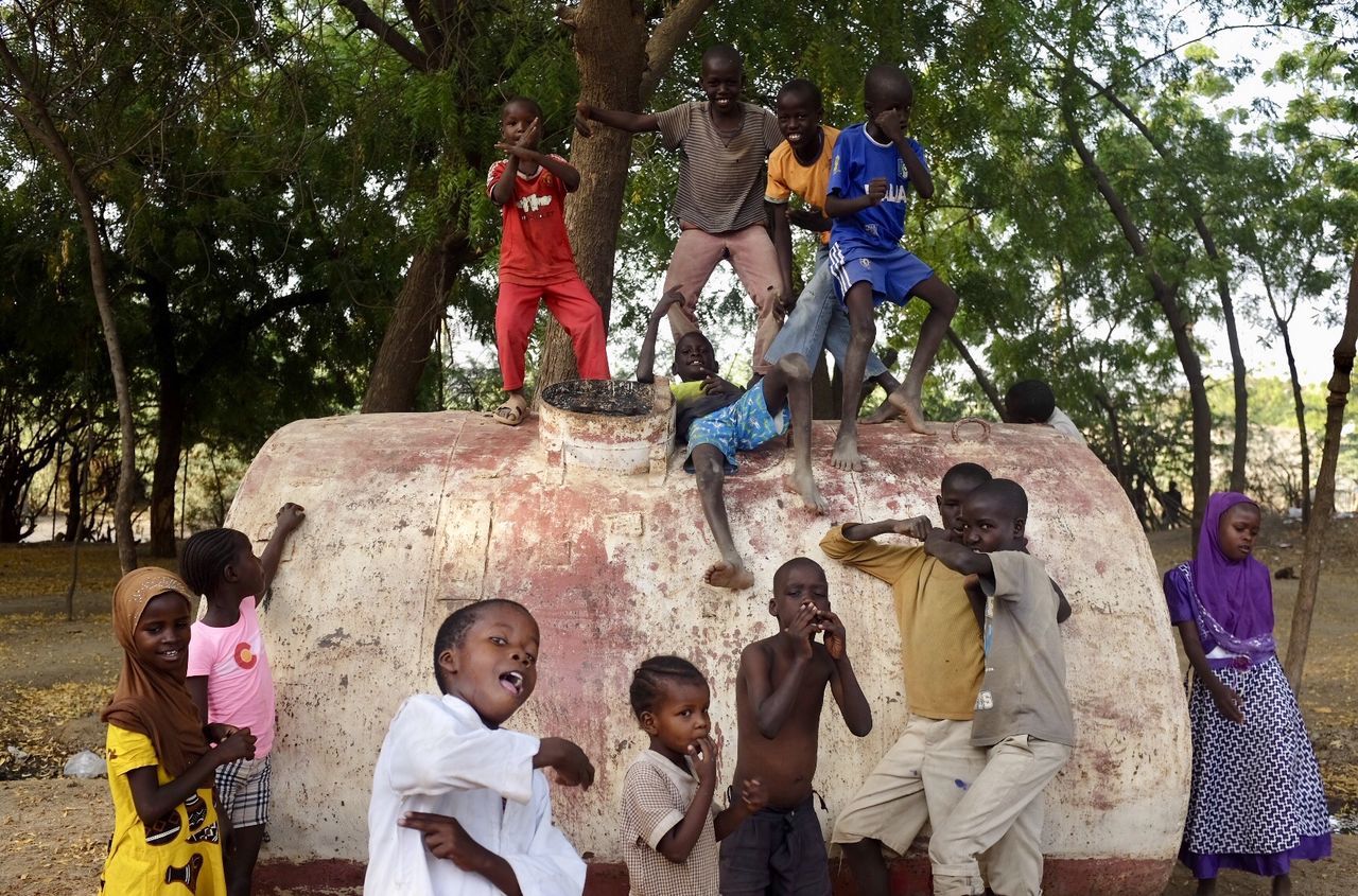 tree, medium group of people, boys, real people, childhood, casual clothing, outdoors, togetherness, day, men, fun, girls, standing, lifestyles, women, friendship, young adult, people, adult