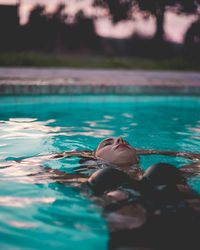 Young woman swimming in pool