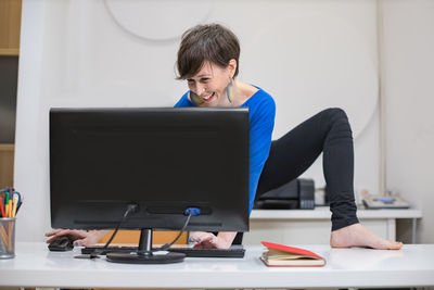 Businesswoman using laptop at office