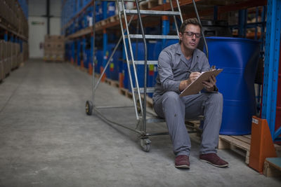 Worker taking stock in warehouse