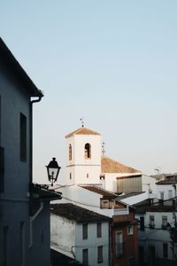 Church and buildings against sky