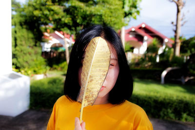 Portrait of a girl covering face