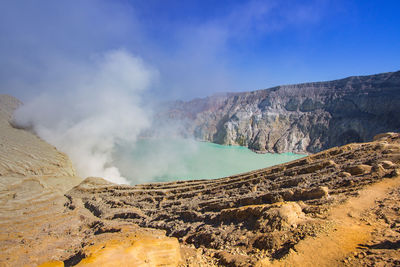 Panoramic view of mountain range against blue sky