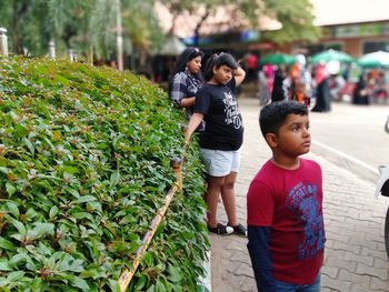 Rear view of people with daughter on plants