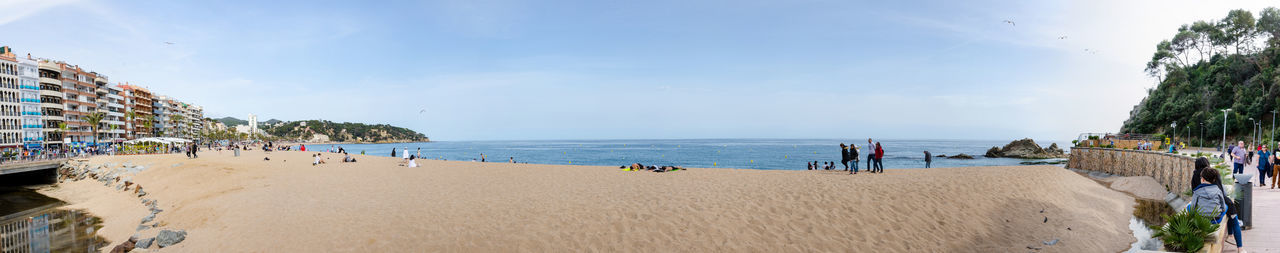 People on beach against sky
