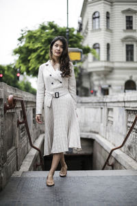 Portrait of young woman standing outdoors