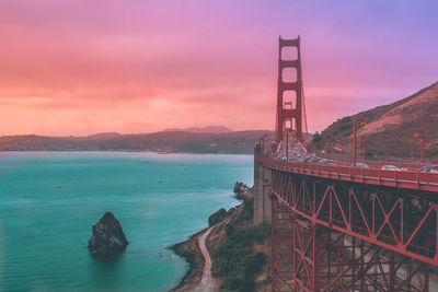 View of bridge over sea against cloudy sky