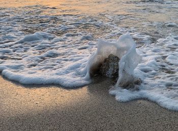 High angle view of waves splashing on shore