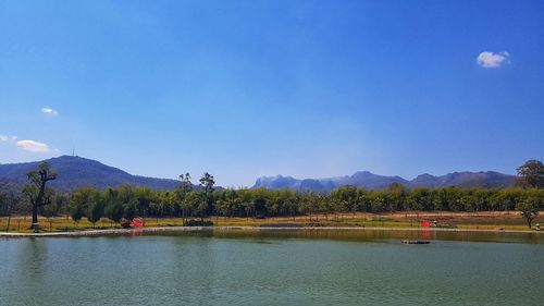 Scenic view of lake against blue sky