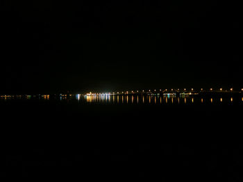Illuminated building against sky at night