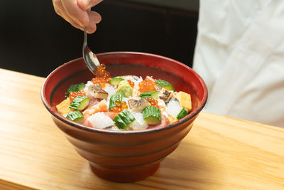 Close-up of person holding food on table