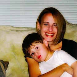 Portrait of happy mother with son at home