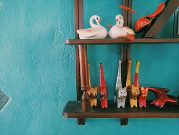 Stuffed toy on table against wall