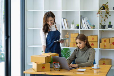 Portrait of woman using laptop at home