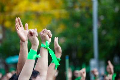 Midsection of woman with arms raised