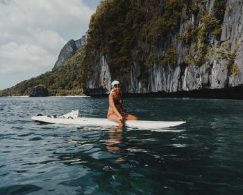 Full length of man on rock in sea