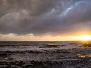 Scenic view of sea against dramatic sky