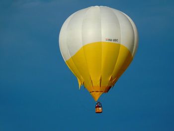 Low angle view of hot air balloon against clear blue sky