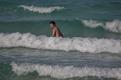 Full length of shirtless man in sea