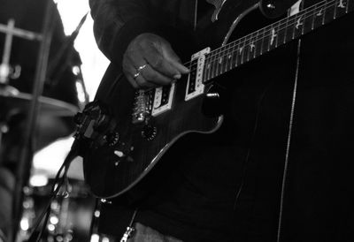 Cropped view of man playing guitar