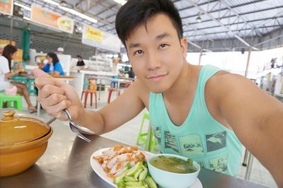 Portrait of man having food in restaurant