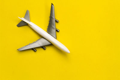 High angle view of airplane on yellow background