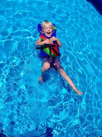 Portrait of happy boy playing in swimming pool