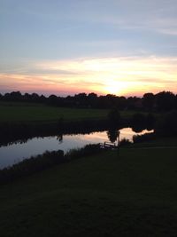 Scenic view of lake at sunset