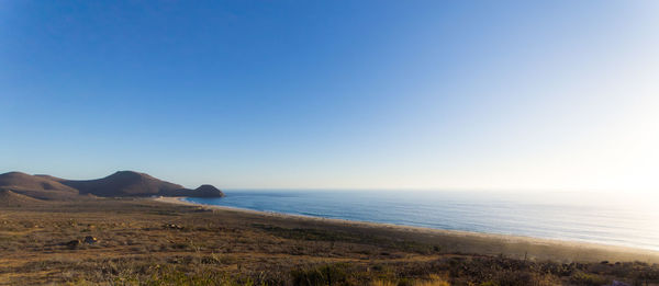 Scenic view of sea against clear blue sky