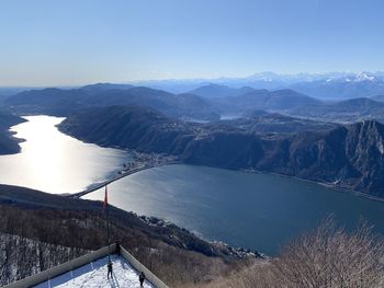 High angle view of lake and mountains against sky