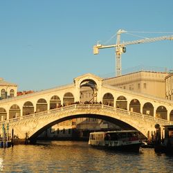 Boats in river with buildings in background