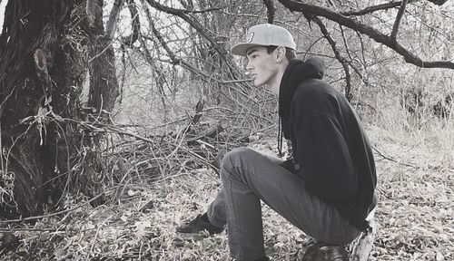 Side view of a young man on plants