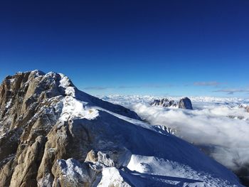 Scenic view of snowcapped mountains against clear blue sky