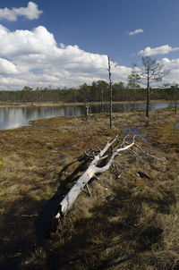 Scenic view of lake against cloudy sky