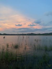 Scenic view of lake against sky during sunset